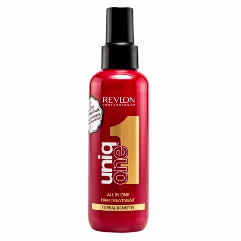 Frasco com o rótulo "Revlon Professional Uniq One All in One Hair Treatment". Na parte inferior do frasco, há um rótulo dourado com o texto "10 Real Benefits". O produto parece ser um tratamento capilar multibeneficios da linha profissional da Revlon.