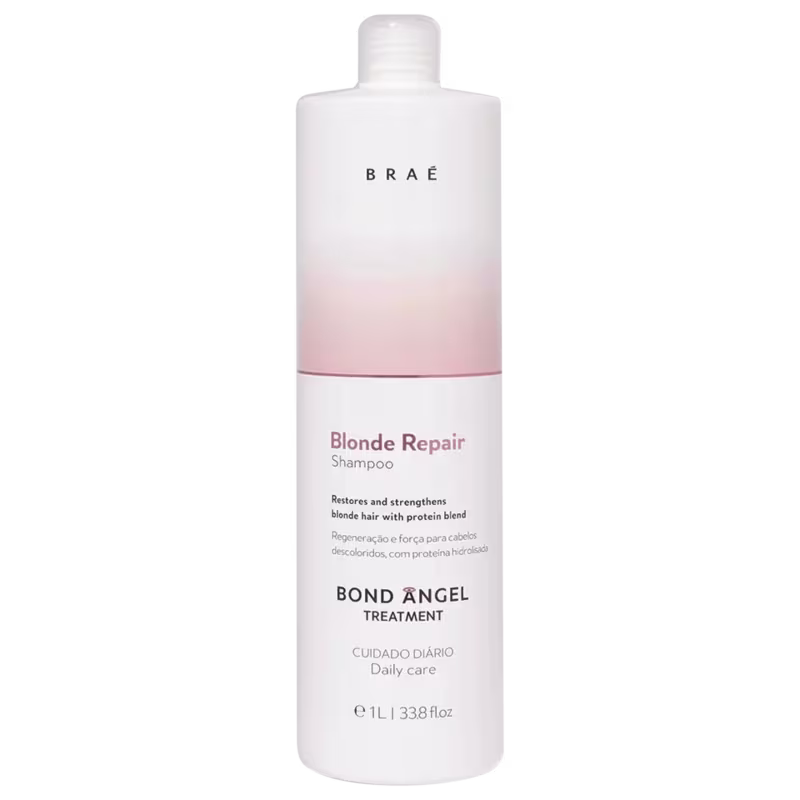 A imagem mostra o frasco de 1 litro do shampoo Bond Angel Blonde Repair de Braé. Seu frasco é tubular, cilíndrico branco, na parte superior há detalhes em degradê de rosé gold.
