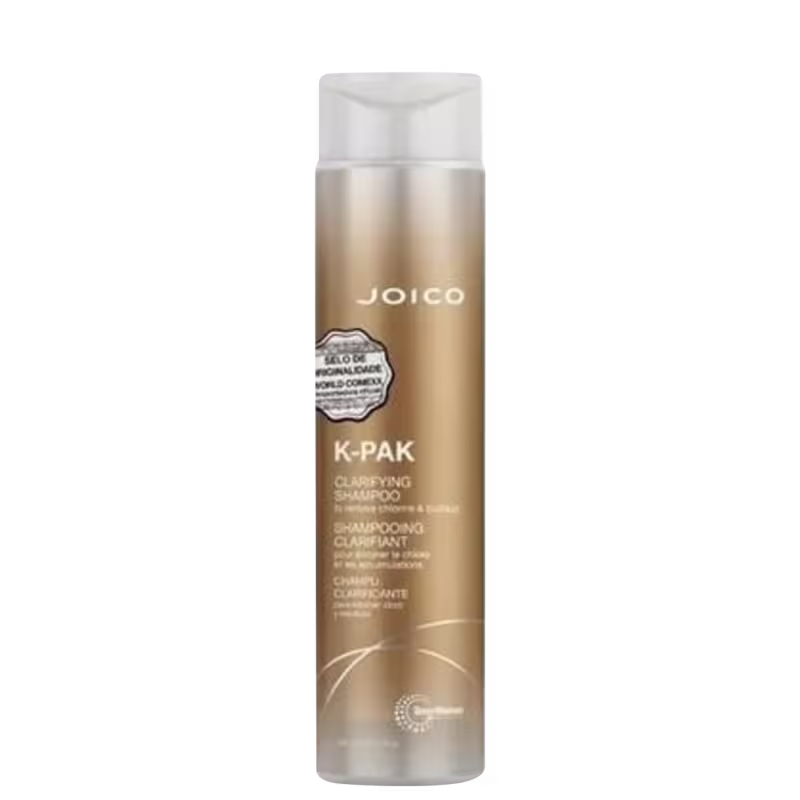 A imagem mostra a embalagem do shampoo que é dourada com detalhes prateados da marca Joico.
