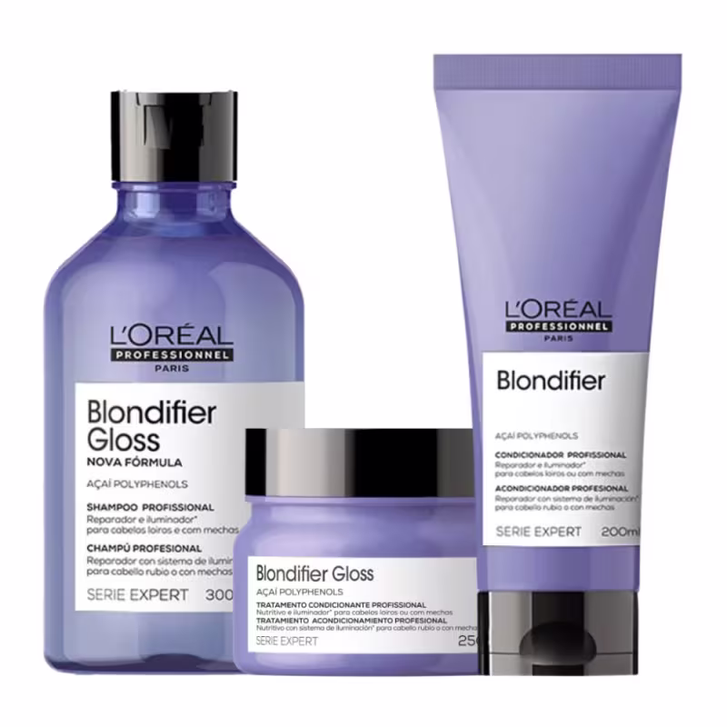 A imagem mostra três produtos da linha Blondifier da L'Oréal Professionnel. Um shampoo em um frasco azul transparente de 300ml, um condicionador em um tubo roxo opaco de 200ml e uma máscara em pote redondo azul. Todos possuem tampa preta.