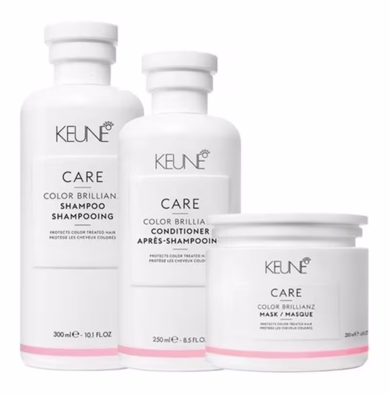 linha de cuidados para cabelos coloridos da marca Keune. Ela consiste em um shampoo, um condicionador e uma máscara, todos com a mesma embalagem branca e rosa.