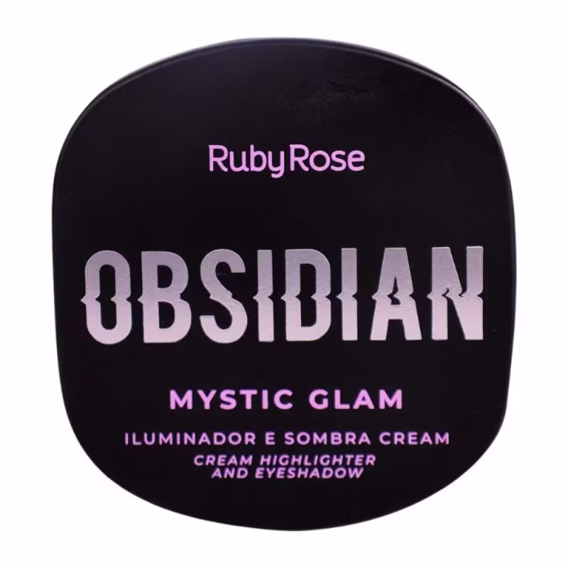 Embalagem fechada do iluminador multifuncional. Apresenta o nome do produto "Obsidian Mystic Glam" em letras grandes na cor lilás. Abaixo, está escrito "Iluminador e Sombra Cream" em português também em letras lilás sobre fundo preto.