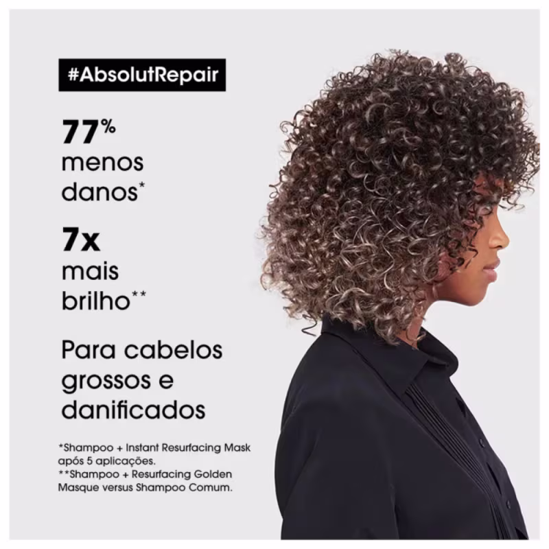 É um anúncio de produtos para cabelos grossos e danificados da linha AbsolutRepair da L'Oréal Professionnel. A imagem mostra uma mulher de perfil com cabelos cacheados e volumosos em tons castanhos. Texto destaca os benefícios.