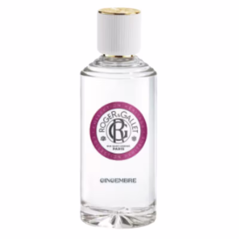 Perfume em frasco de vidro transparente com tampa branca e detalhes dourados. Embalagem cilíndrica com rótulo circular vinho com o logotipo Roger & Gallet em branco. Texto "Gingembre" (Gengibre) na parte inferior do frasco.