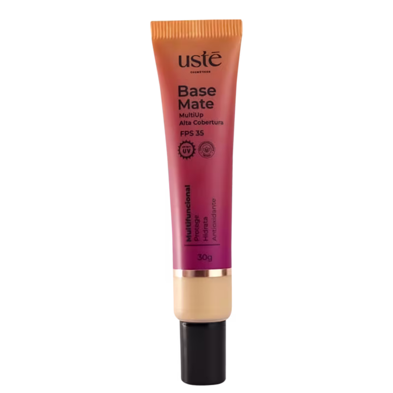 Base Matte da Ustē Cosméticos. Produto de maquiagem em embalagem plástica cilíndrica de cor laranja e rosa. Rótulo indicando FPS 35 e proteção UV. Tubo de 30g com detalhes em preto e dourado na parte inferior.