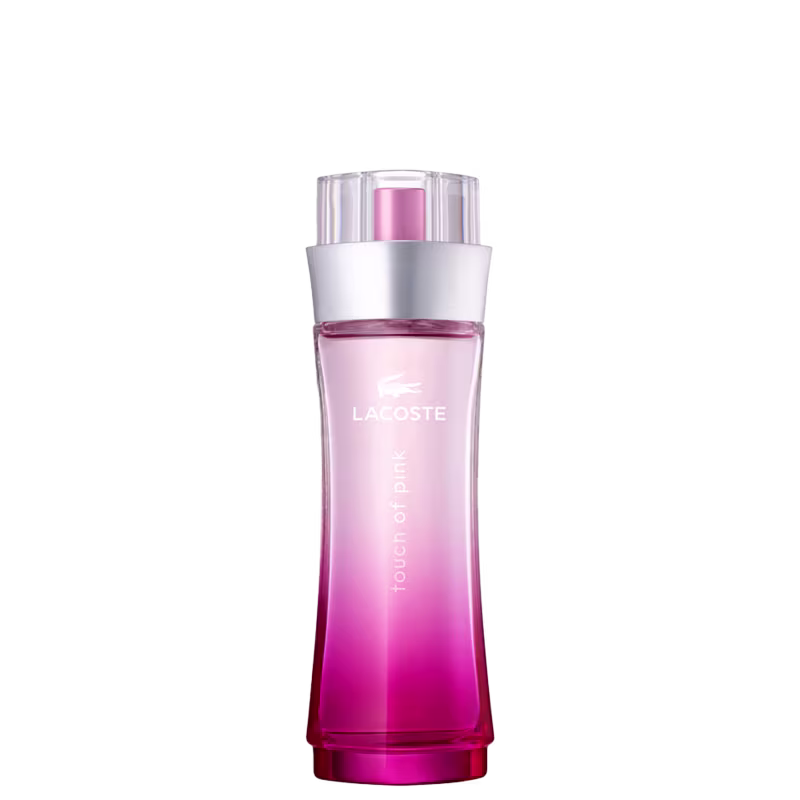 Perfume em frasco cilíndrico transparente com gradiente de cores rosa e laranja. O frasco possui uma tampa plástica transparente. Na parte frontal do frasco, está impresso o logotipo "Lacoste" em letras maiúsculas brancas.