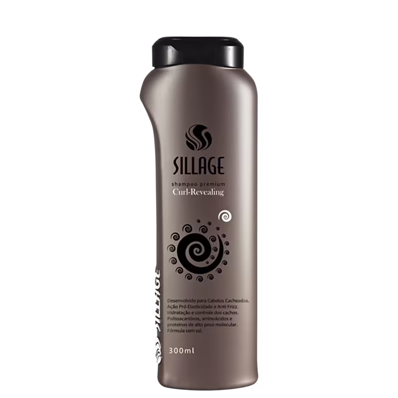 Frasco de shampoo premium da marca Sillage, com design moderno e elegante em tons de cinza. O rótulo destaca o nome da linha "Curl-Revealing" e apresenta detalhes gráficos em espiral, indicando seu propósito de realçar os cachos.