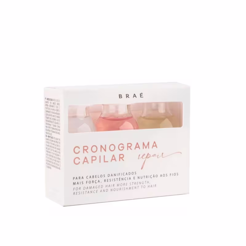 É um conjunto de frascos de tratamento capilar da marca Brae. A embalagem é uma caixa branca com o nome "Cronograma Capilar Repair" em letras alaranjadas e texto explicativo em português e inglês.