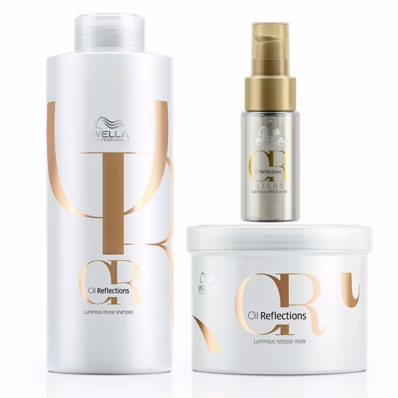 Três produtos da linha Oil Reflections da marca Wella Professionals. Um é um shampoo luminoso em um frasco cilíndrico branco com detalhes em dourado. Outro é um óleo capilar. O terceiro é uma máscara de tratamento em um pote branco com detalhes em dourado