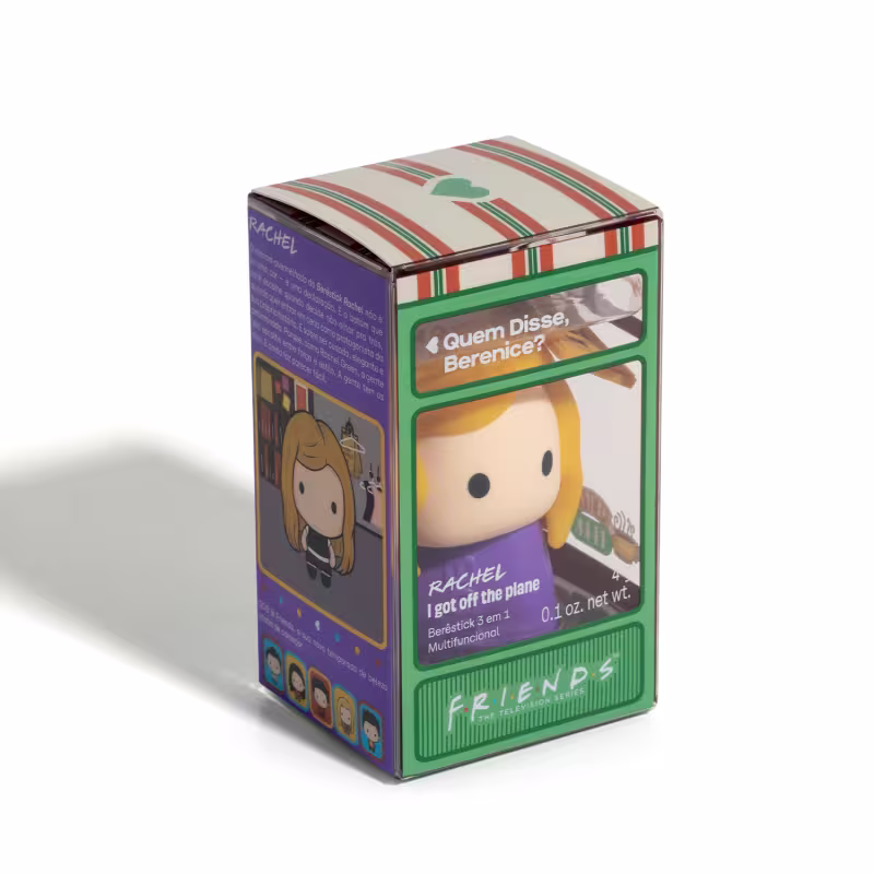 Caixa de presente retangular com design listrado em tons de laranja, verde e branco. Exibe o nome da marca "Friends" e uma ilustração de um personagem feminino. A caixa contém um item com a descrição "Quem disse, Berenice?".