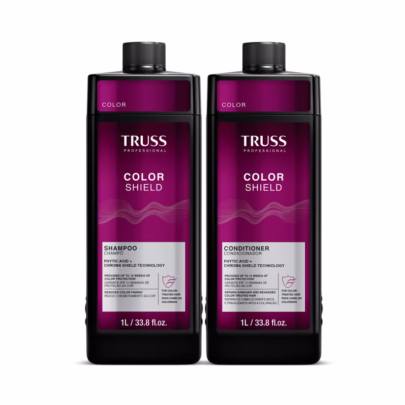 Dois frascos de 1L da linha Color Shield da Truss Professional, contendo shampoo e condicionador para proteção da cor dos cabelos. Embalagens pretas com detalhes em roxo, exibindo o nome da marca e do produto.
