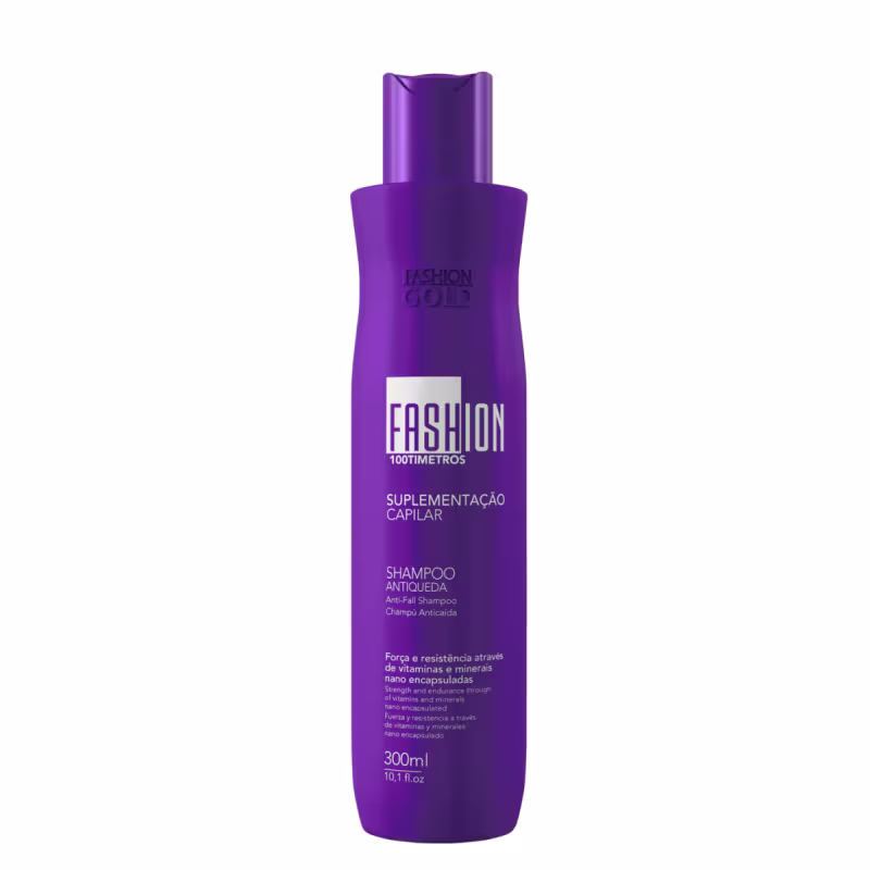 Frasco de shampoo da linha Fashion Gold, na cor roxa, com rótulo destacando o nome "Fashion" e "100 Timetros". O produto é descrito como "Suplementação Capilar" e "Shampoo Antiqueda".