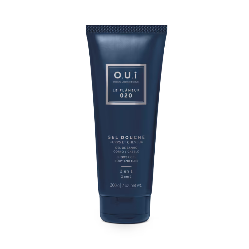 A imagem mostra o tubo do gel de banho 2 em 1 para corpo e cabelos. É uma embalagem plástica de 200g azul escura com o nome da marca O.U.i e alguma informações adicionais da fórmula. O design é sofisticado e elegante.