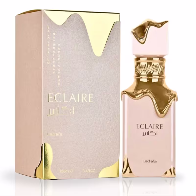 Frasco de perfume Eclaire da marca Lattafa, com embalagem em tons de bege e dourado. O frasco possui um design elegante e detalhes dourados, com o nome da fragrância destacado em letras douradas.
