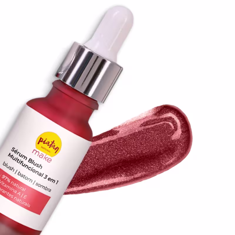 A imagem mostra o sérum Blush e ao fundo uma amostra da cor e textura líquida do produto. Possui acabamento perolado em tom rosa avermelhado.