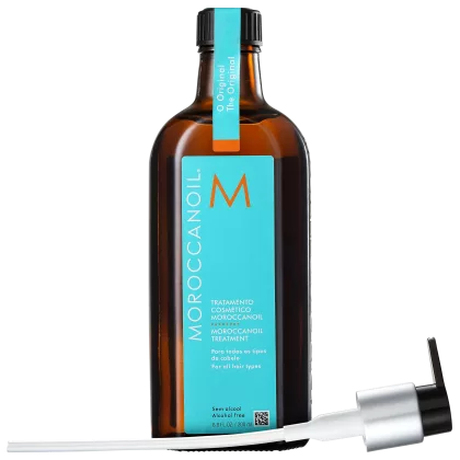 A imagem mostra o Óleo Cpailar Moroccanoil em frasco âmbar de 200ml. Embalagem retangular com rótulo azul turquesa e logotipo M em laranja. Na parte de baixo, um aplicador de plástico branco e preto acompanha o frasco.