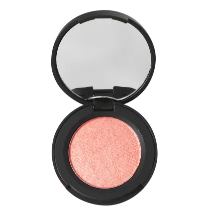 A imagem mostra um blush compacto Océane em uma embalagem preta redonda. O espelho embutido na tampa permite ver o brilho perolado da maquiagem rosa coral prensada dentro da base.