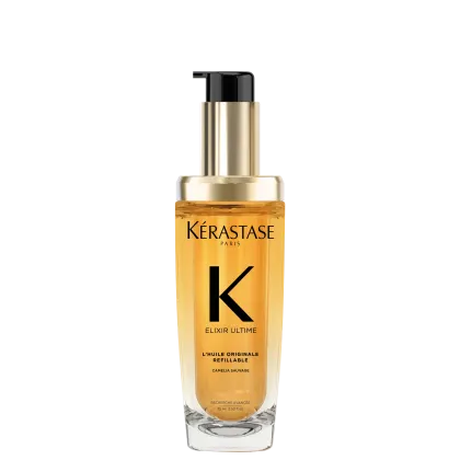 A imagem mostra o óleo capilar da marca Kérastase. O frasco é transparente, permitindo ver o líquido dourado dentro. O frasco tem um formato cilíndrico e uma bomba dosadora preta no topo. O rótulo apresenta letras pretas sobre um fundo dourado.