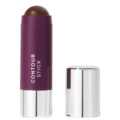 A imagem mostra o produto Contour Stick da marca Océane. Um bastão de maquiagem em formato cilíndrico com embalagem roxa e tampa prateada ao lado. O nome do produto "CONTOUR STICK" está impresso em letras brancas sobre a cor roxa.
