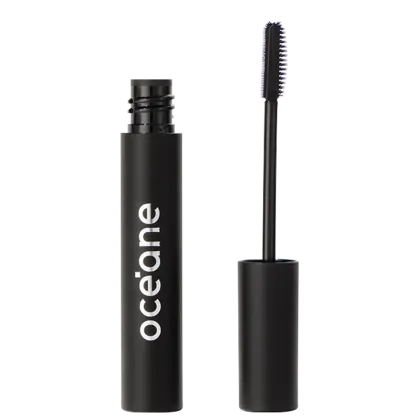 A imagem mostra o Gel Incolor para Sobrancelhas Océane Purple Instant Brows, em um tubo preto cilíndrico com o nome "Océane" impresso em letras brancas e ao lado uma escova aplicadora de cerdas brancas espiraladas.
