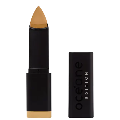 A imagem mostra a Base em Bastão Océane Edition Foundation Stick aberta e com a tampa do lado. Possui embalagem preta fosca com o logotipo "Océane Edition" impresso em letras brancas e pretas. A ponta da base tem formato triangular.