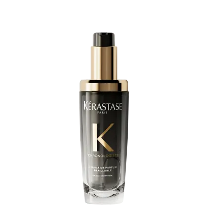 Frasco de óleo de perfume refinável da linha Chronologiste da Kérastase, com design elegante em tons de dourado e preto, destacando o logotipo da marca.