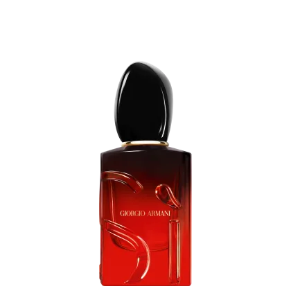 O frasco possui um formato retangular com uma tampa oval, com a marca "Giorgio Armani" impressa em destaque. A cor predominante é o vermelho escuro, com um acabamento brilhante.