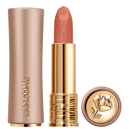 Embalagem dourada e rosa de um batom da marca Lancôme, com o nome da marca em relevo. O batom possui uma cor coral vibrante e a tampa da embalagem apresenta um desenho floral dourado.