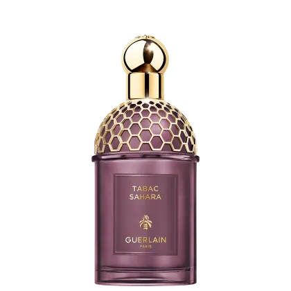 Frasco de perfume Guerlain Tabac Sahara, com design elegante e geométrico em tons de roxo e dourado, destacando o nome da fragrância e a marca.