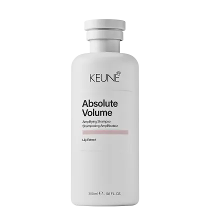 Frasco branco da linha Absolute Volume da Keune, contendo shampoo amplificador de volume com extrato de lírio. Embalagem cilíndrica com tampa e rótulo preto e branco destacando o nome do produto.