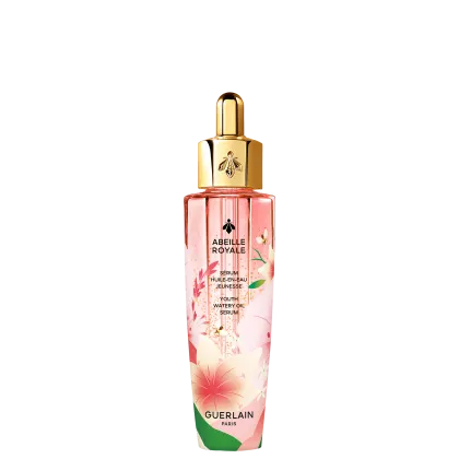 Frasco de vidro rosa com tampa dourada contendo o sérum "Abeille Royale" da Guerlain, com detalhes florais e texto em francês descrevendo o produto como um sérum de óleo aquoso para juventude.