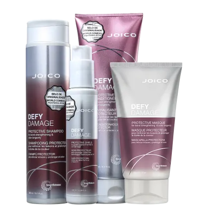 Produtos da linha Defy Damage da Joico, incluindo shampoo protetor, condicionador protetor e máscara protetora, em embalagens de plástico branco e rosa com detalhes em prata.