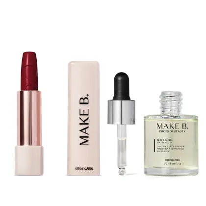 Dois produtos da marca  Make B. Urban Ballet, sendo um batom vermeho em embalagem dourada e branca com tampa branca e letras pretas e um vidro com líquido transparente, tampa prateada com conta-gotas preto de elixir facial.