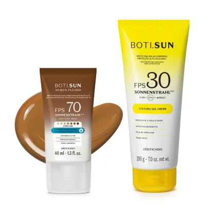 Dois produtos de proteção solar da marca Boti Sun: um frasco de protetor solar facial FPS 70 Cor 06 em bisnaga marrom e branca e uma frasco protetor solar corporal FPS 30 em bisnaga amarela e branca com tampa amarela.