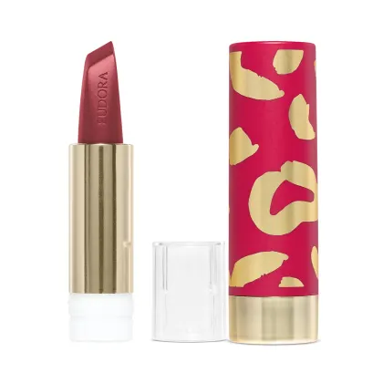 Na imagem há a case de um batom. Ela tem um padrão de manchas abstratas em rosa vibrante e dourado metálico. Esse design moderno e sofisticado com cores vivas é característico de uma linha de cosméticos glam e de luxo.