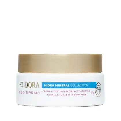 Embalagem tipo pote do Creme hidratante facial fortalecedor da linha Hidra Mineral da Eudora. Embalagem branca com tampa de rosquear dourada na parte superior, rótulo em tons de verde, vermelho e dourado no fundo branco.