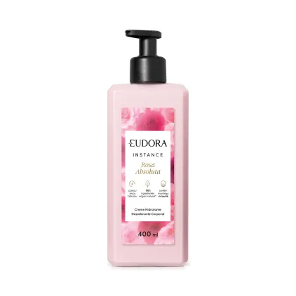 Creme hidratante desodorante corporal da linha Instance de Eudora. A embalagem é um frasco plástico rosa claro com um rótulo branco destacando o nome "Rosa Absoluta" e informações sobre o produto. O frasco possui um dispensador preto na parte superior.