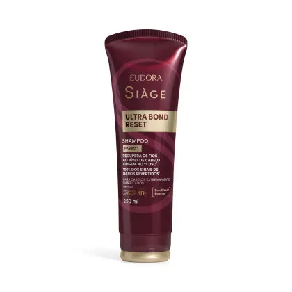 Frasco de shampoo da marca Siàge, na cor vinho, com rótulo em dourado contendo o texto "Ultra Bond Reset" e informações sobre recuperação dos fios.