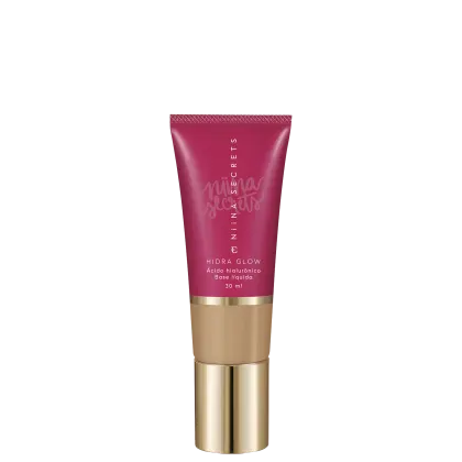 Tubo de base líquida Hidra Glow da marca Niina Secrets, com embalagem rosa e detalhes dourados, contendo 30 ml de produto.