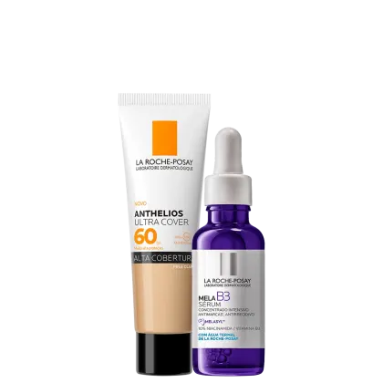 A imagem mostra um protetor solar facial com cor com embalagem tipo bisnaga, ao lado de um frasco de sérum facial com azul, rótulo cinza e conta-gotas branco.