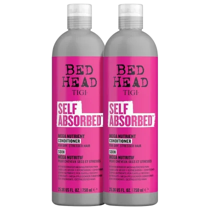 Dois frascos de condicionador Bed Head da TIGI, na cor rosa vibrante, com rótulos indicando "Self Absorbed" e "Mega Nutrient Conditioner" para cabelos secos e estressados. Cada frasco possui 25,36 fl oz (750 ml) de produto.