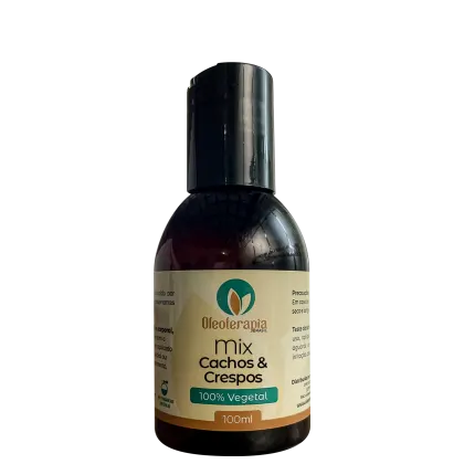 O produto apresentado é um frasco de 100ml da linha "Mix Cachos & Crespos" da marca Oleoterapia Brasil. O frasco possui um design cilíndrico com tampa preta e rótulo verde e amarelo, indicando que se trata de um produto 100% vegetal.
