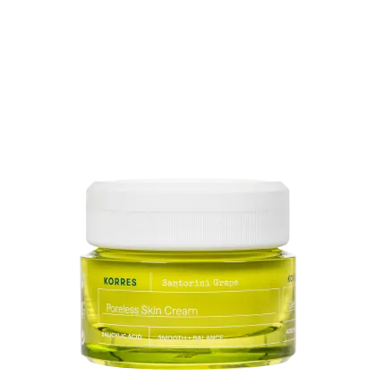 Frasco de creme facial da marca Korres, com rótulo amarelo e branco indicando "Poreless Skin Cream" e "Santorini Grape". O produto contém um líquido de coloração amarelo-esverdeada.