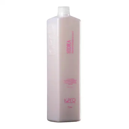 Hidra Shampoo Hidratante Nutritivo da linha K.Pro. Embalagem plástica na cor rosa claro. Rótulo com o nome do produto "HIDRA" em letras maiúsculas rosa e a descrição "shampoo hidratante nutritivo" abaixo em letras menores.