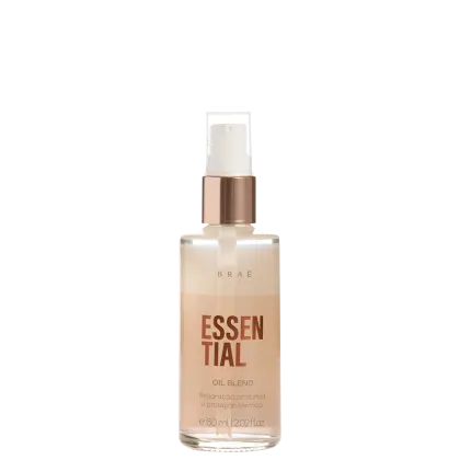 Óleo essencial Brae em frasco transparente de 60ml/2.02fl oz. Embalagem com tampa rosada metálica. Rótulo com texto "ESSENTIAL OIL BLEND" e "Reparação profunda e proteção térmica" em letras marrons sobre fundo bege claro.