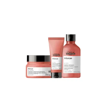 Produtos da linha Enforcer da L'Oréal Professionnel, incluindo um frasco de shampoo, um tubo de condicionador e uma caixa de tratamento capilar, todos em tons de rosa.