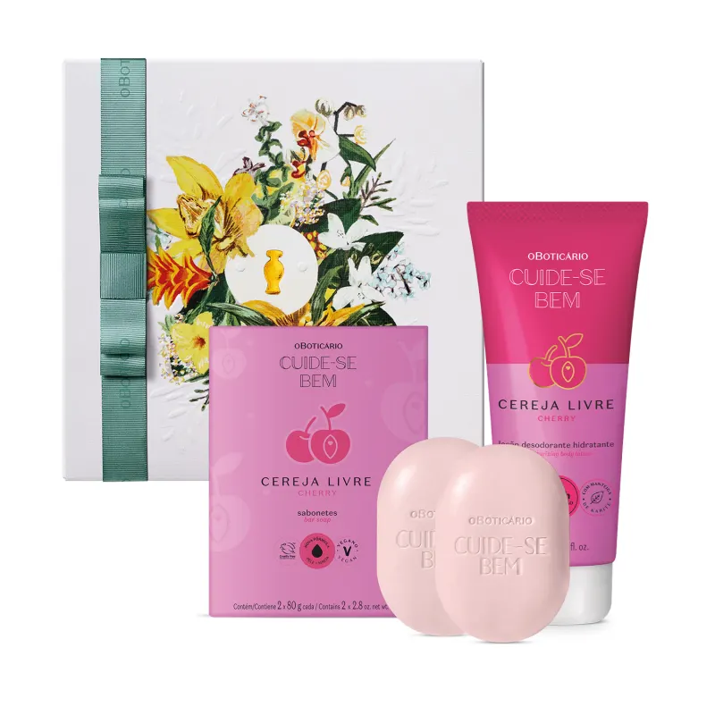 Caixa com flores ilustradas e dois produtos da linha Cuide-se Bem Cereja Livre: dois sabonetes em barra na cor lilás e sua embalagem e um tubo de creme hidratante. As embalagens são em tons de lilás e rosa com rótulos e informações em letras pretas.