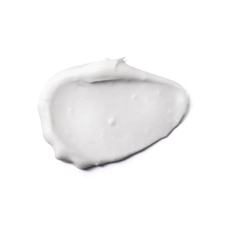 Textura branca e lisa do creme reparador hidratante da marca Boti Baby Cicababy. com aparência opaca e densa, espalhado em superfície branca.