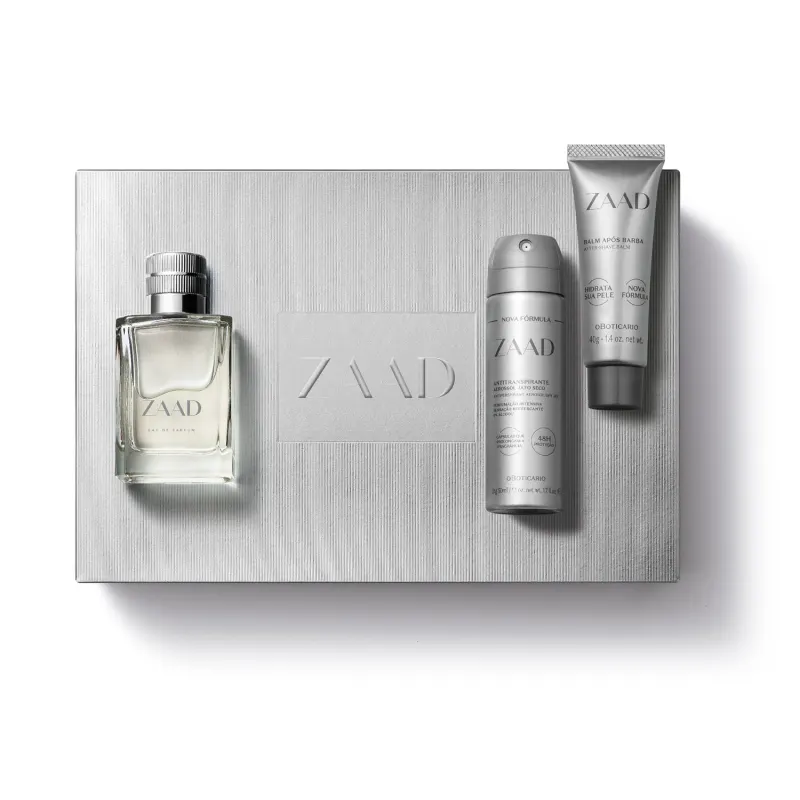 Imagem de um kit com produtos da marca Zaad, sendo uma caixa presenteável, vidro de item de desodorante colônia, desodorante antitranspirante aerossol e balm pós barba. As embalagens têm predominância na cor prata e cinza.
