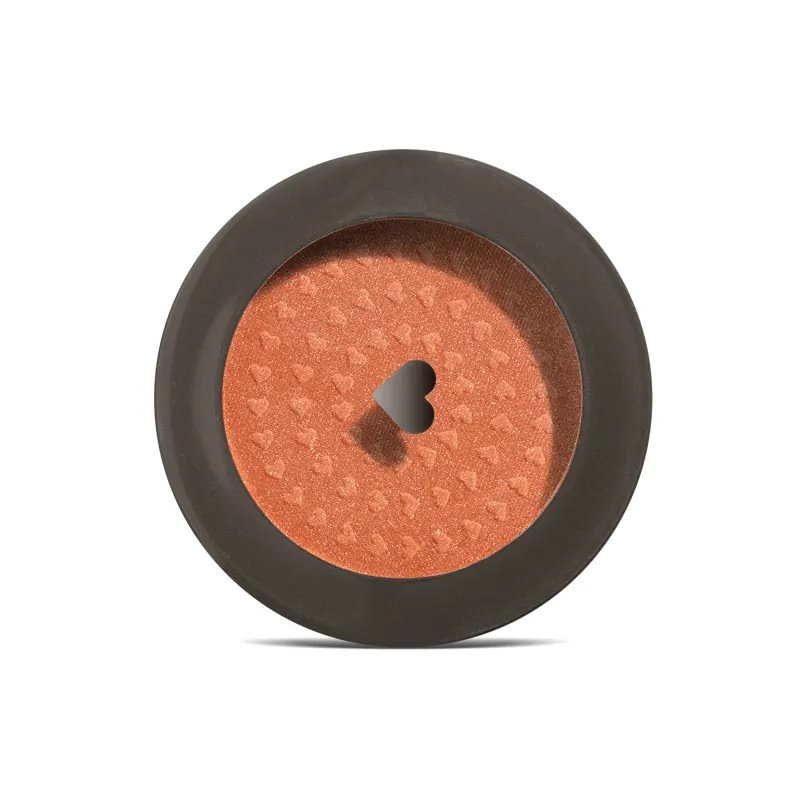 Estojo compacto redondo na cor preta com tampa transparente e coração ilustrado contendo 2g de blush em pó compacto Rubor Cobre Cobrelito da mara Quem Disse, Berenice?.